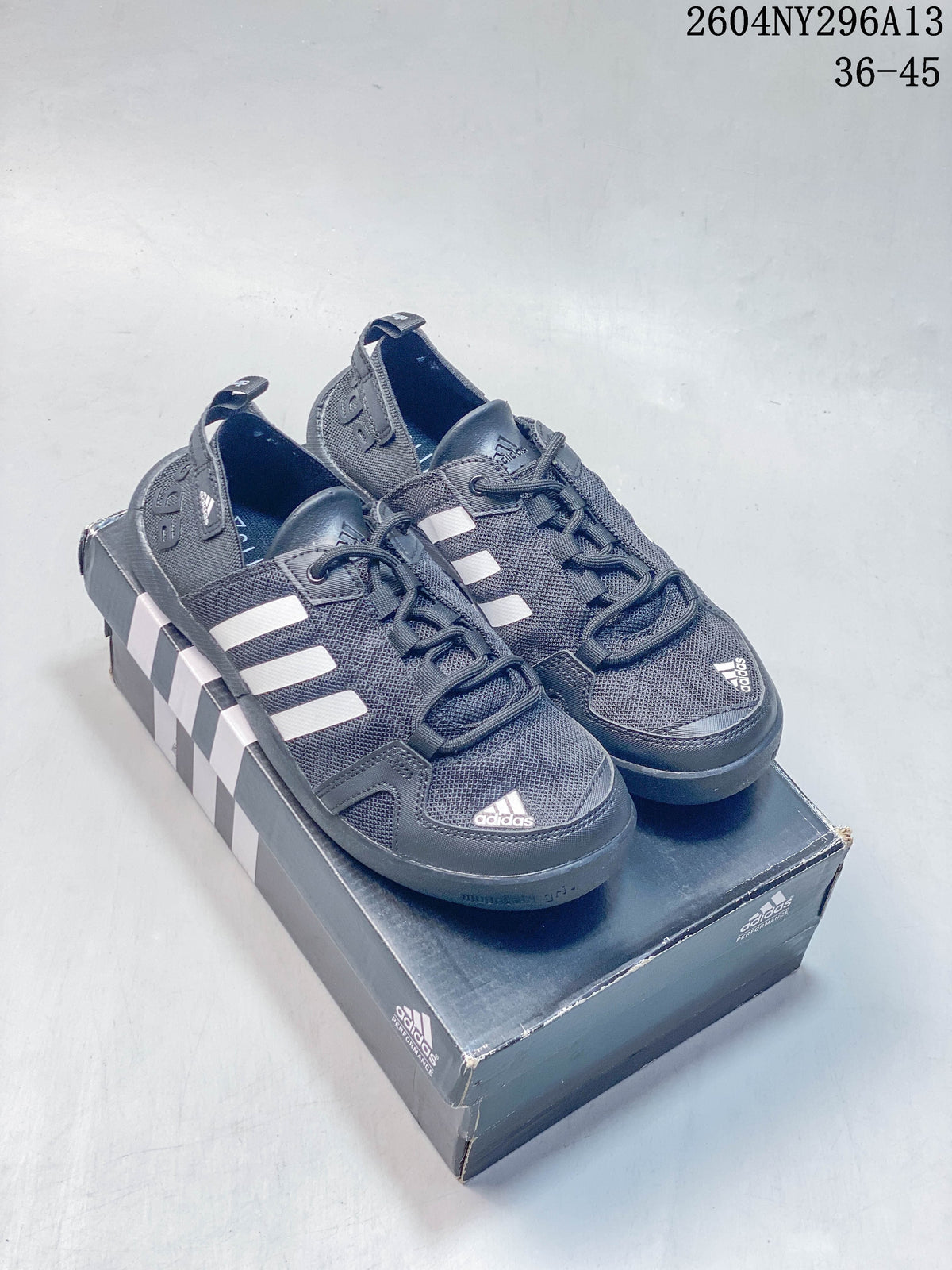 Dark gray adidas TERREX outdoor shoes with white stripes and a textured outsole; image also displays sizes 36–45.