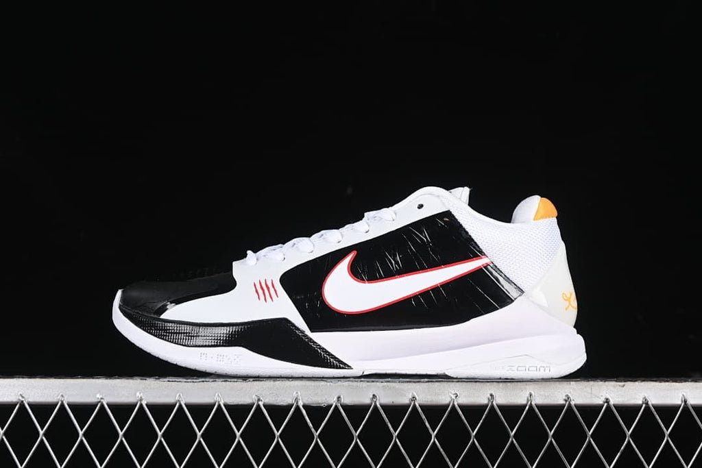 Side view of white and black Nike Kobe 5 Protro shoes with red and yellow accents