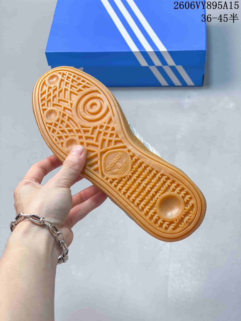 Underside view of the sneaker showing its gum-colored outsole and tread pattern