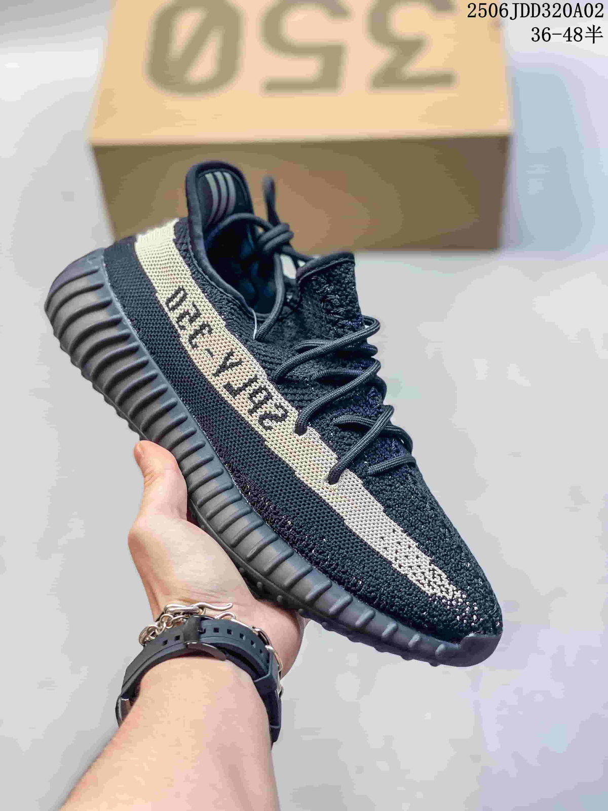Black knit low-top sneaker with a cream side stripe and dark ribbed sole