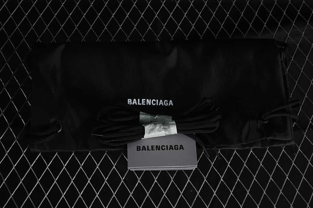 Black branded drawstring shoe bag, spare laces and booklet shown as accessories.
