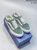 Pair of green Vans Old Skool sneakers with white side stripes and laces