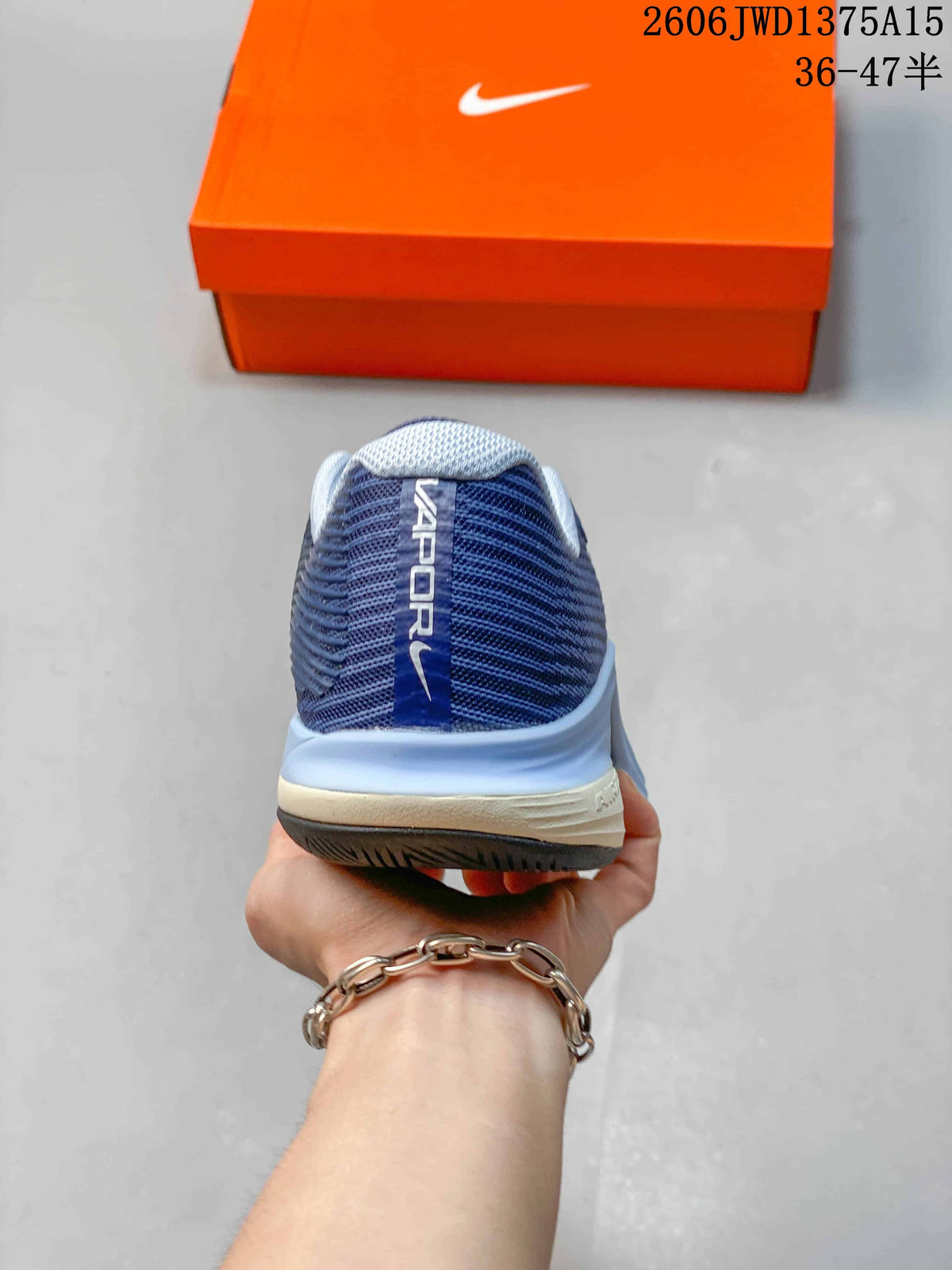 Rear view of a blue Nike Vapor 12 shoe with a padded-looking collar