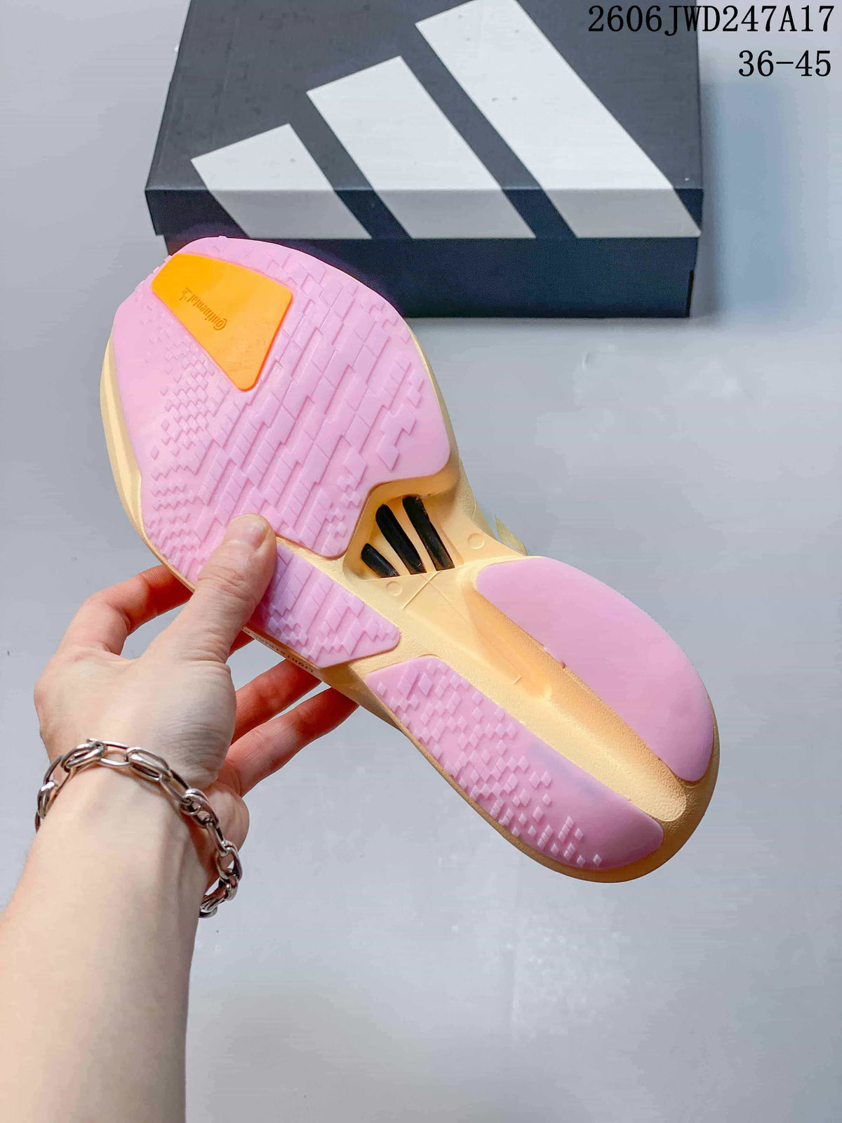 Underside of the shoe showing pink outsole sections and a yellow-orange central area.