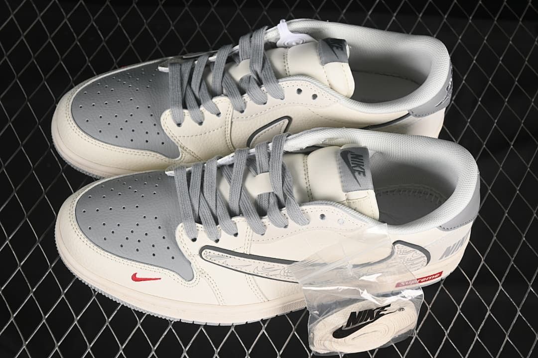 Pair of grey and off-white low-top sneakers viewed from above, with an extra lace set in a bag