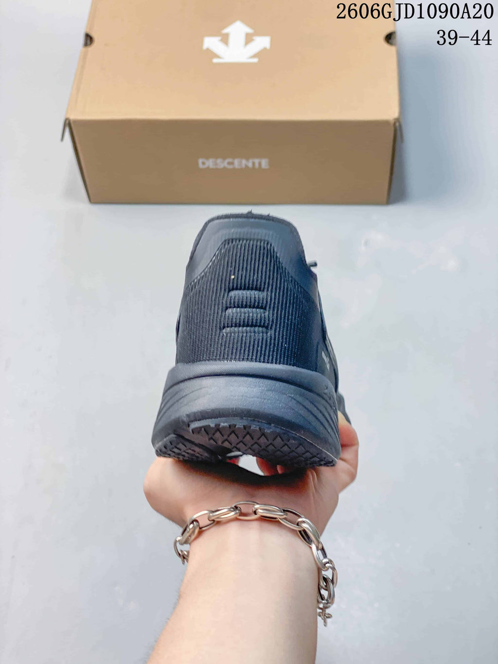 Rear view showing the heel and sole of a dark gray Descente shoe