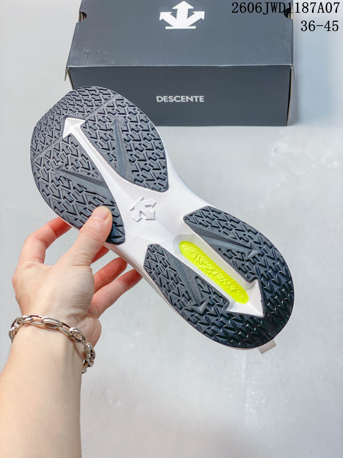 Close-up of the patterned outsole on a white DESCENTE shoe.