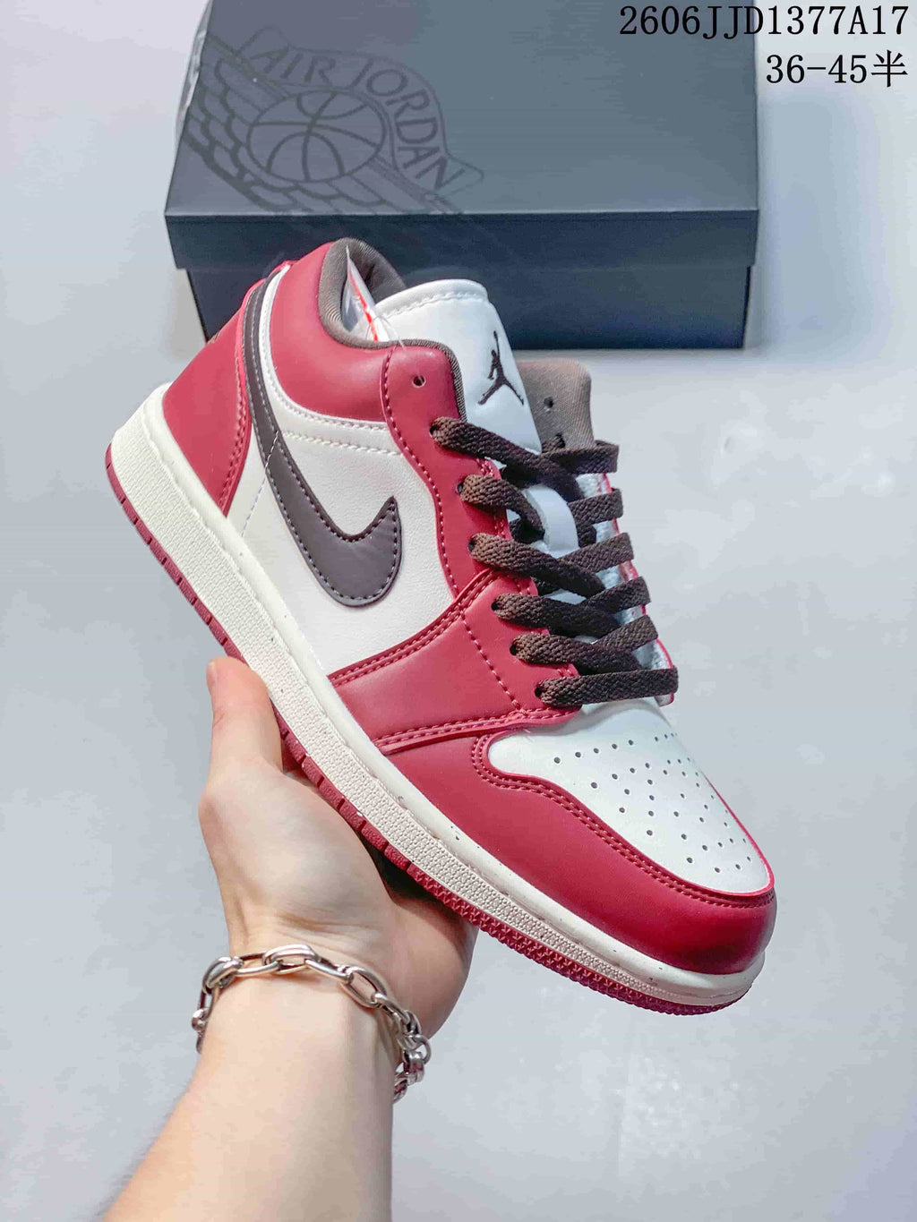 Angled side view of the burgundy, white, and brown sneaker
