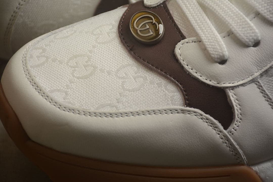 Close-up of the patterned toe panel and circular logo detail
