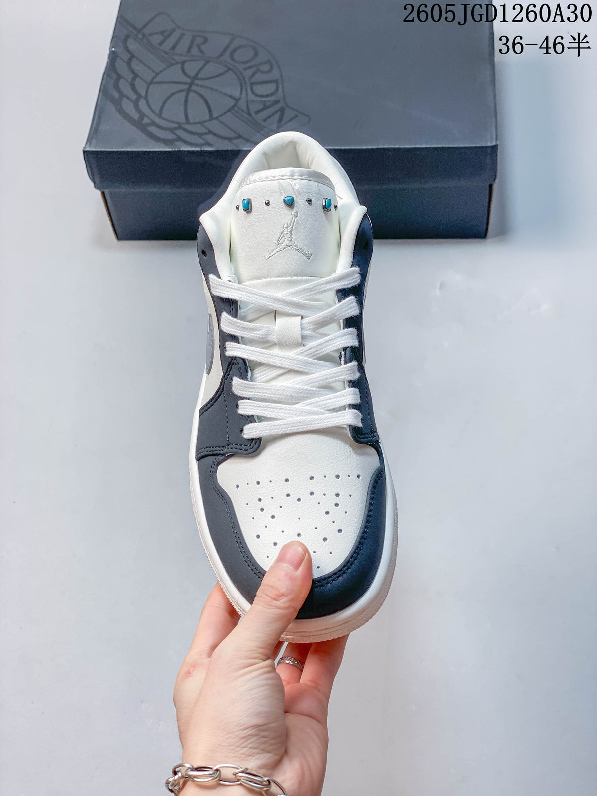 Front view showing the perforated toe, laces, and decorative tongue details