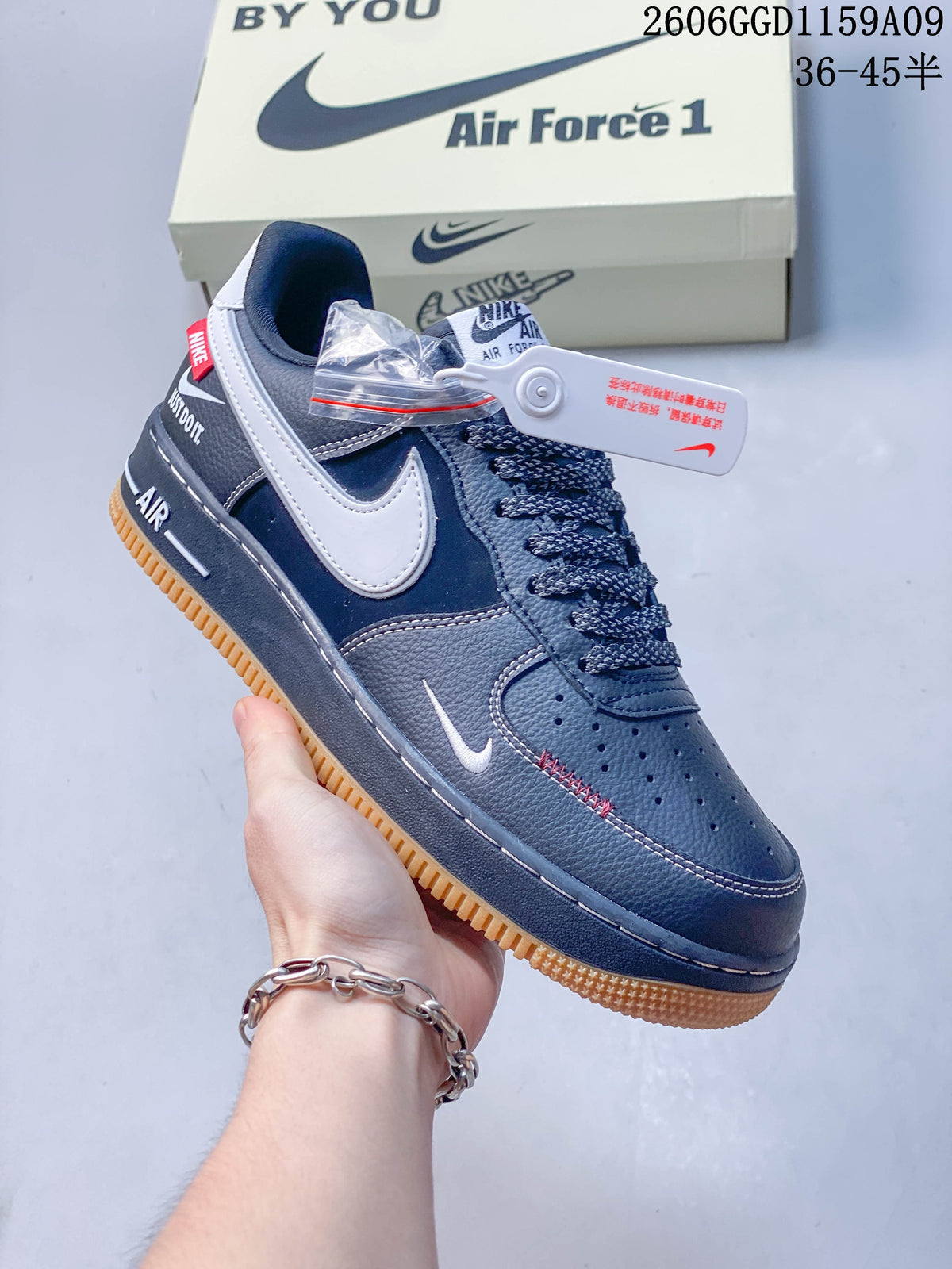 Angled view highlighting the white side Swoosh, small toe-side Swoosh, and red accent stitching.