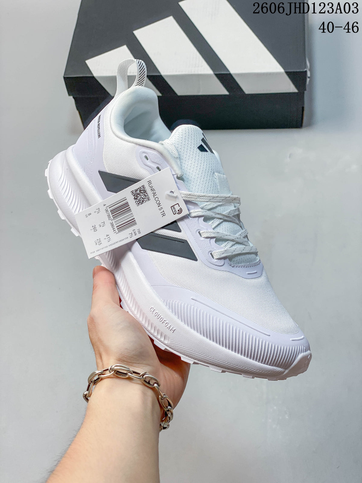 White Adidas Runfalcon 5 TR shoe shown from the side with its product tag.