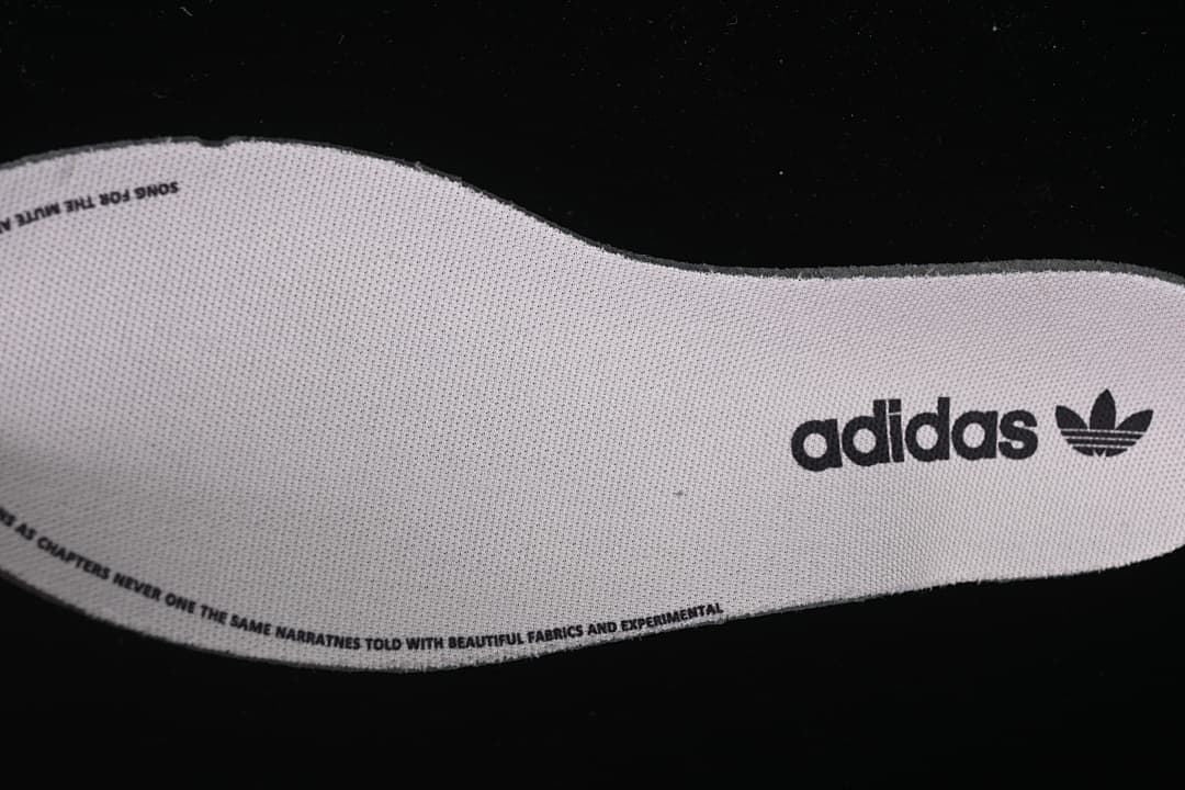 Close-up of an adidas-branded insole with printed text around its edge.