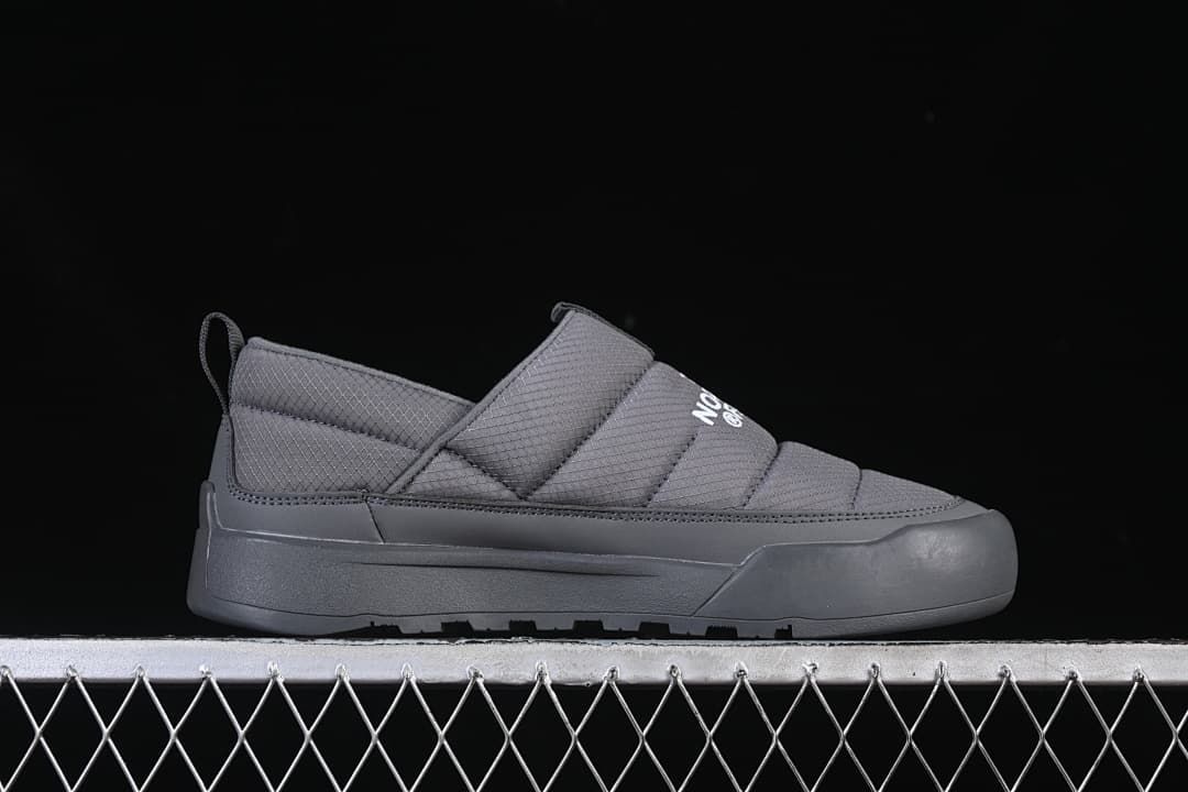 Side profile of a grey slip-on shoe