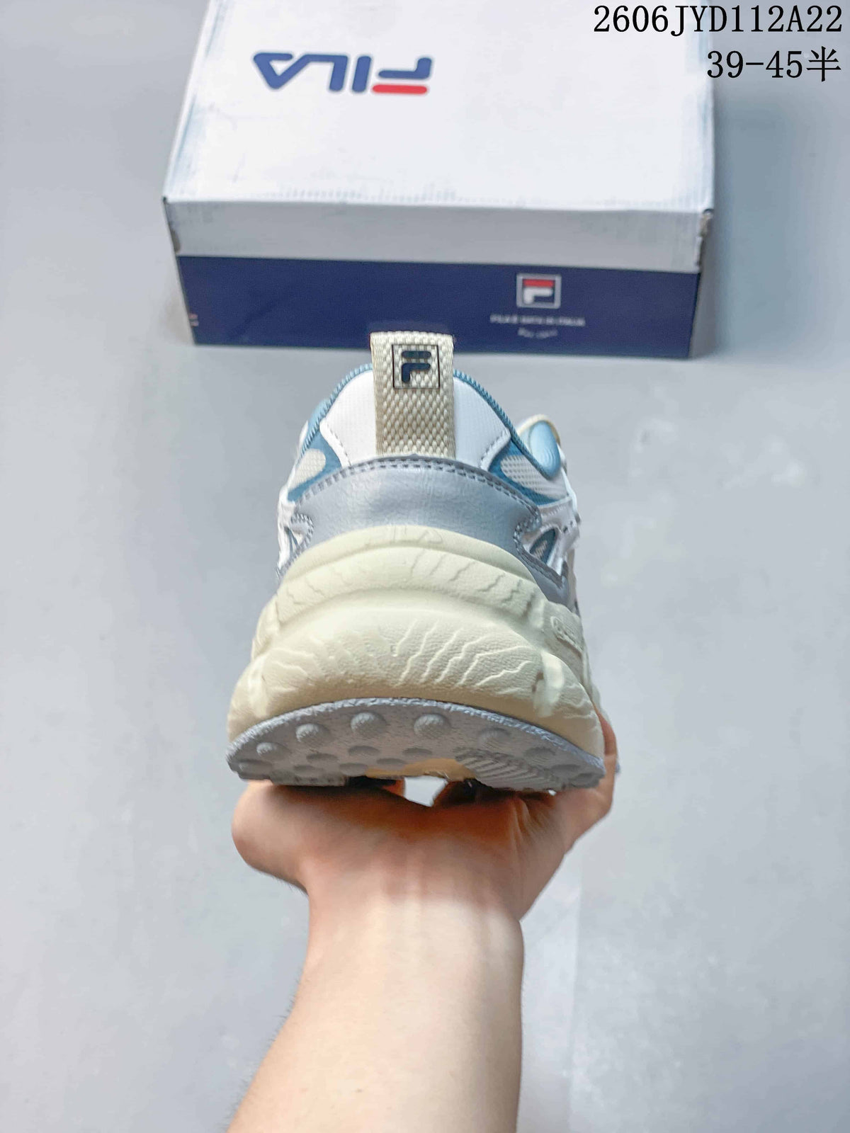 Rear view of a FILA sneaker showing the heel and chunky cream-colored sole.