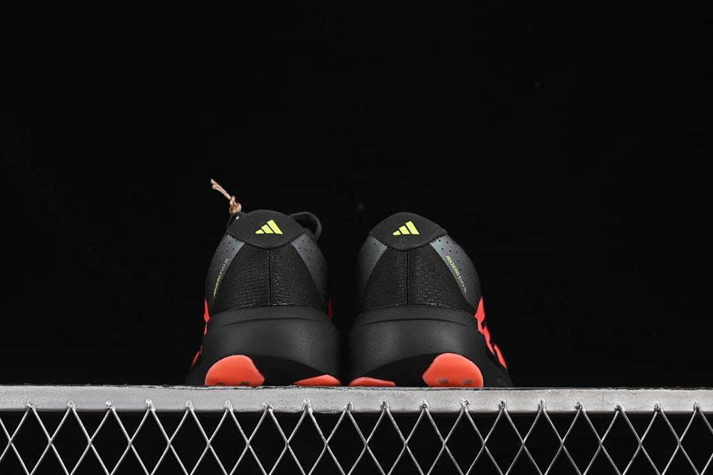Rear view of the pair showing lime heel logos and coral outsole details