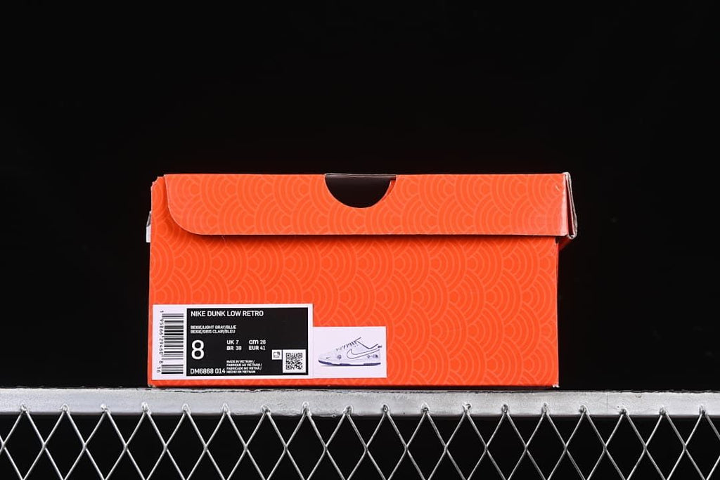 Orange shoebox label showing Nike Dunk Low Retro, style code DM6868-014, and size 8.