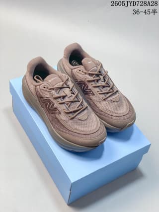 Pair of taupe-brown New Balance running shoes displayed on a blue box