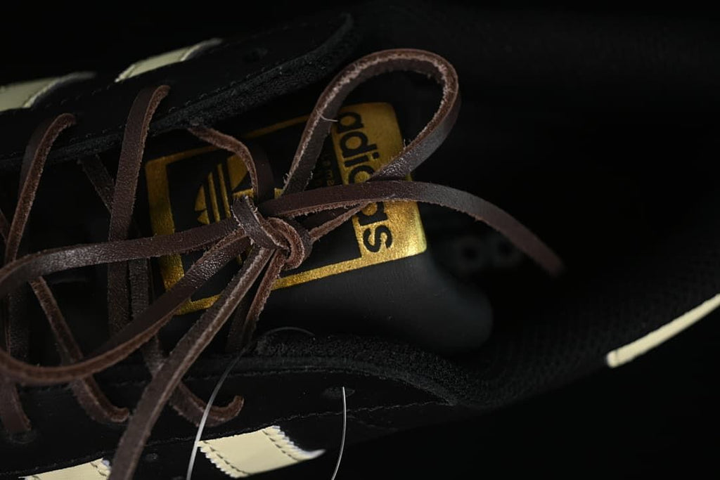 Close-up of the tongue branding and brown lace on the adidas Superstar.