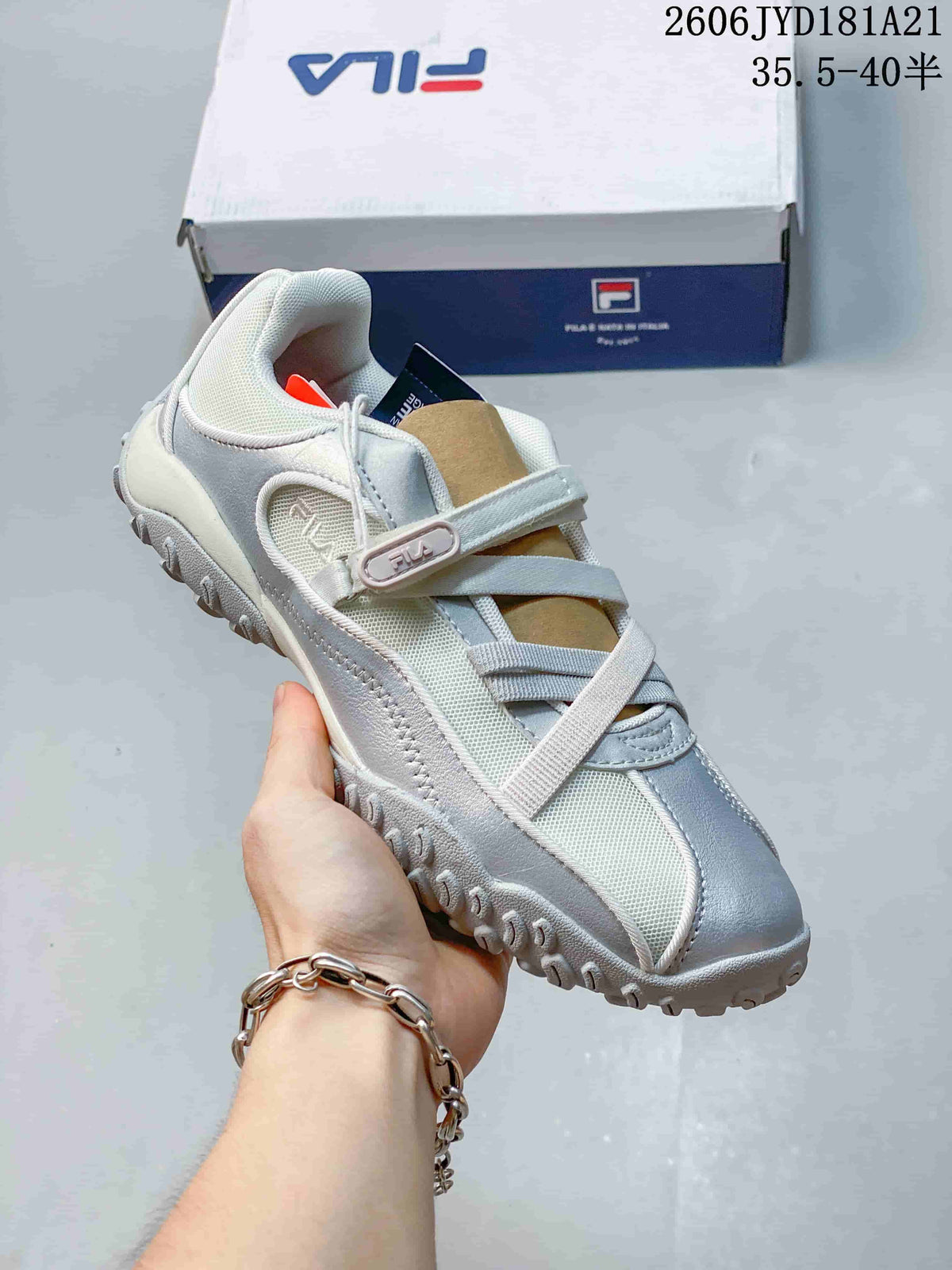 Close-up of a white and gray FILA Pebble Sandal shoe with adjustable strap