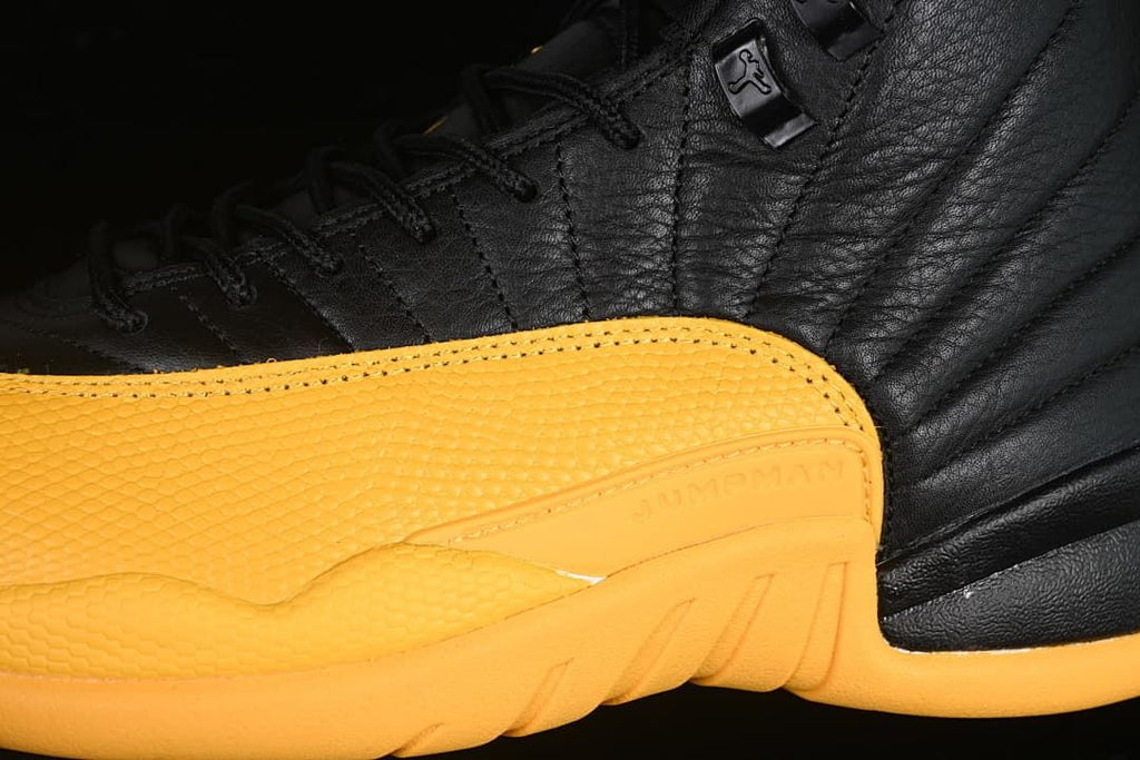 Close-up of the black upper, laces, and gold side panel
