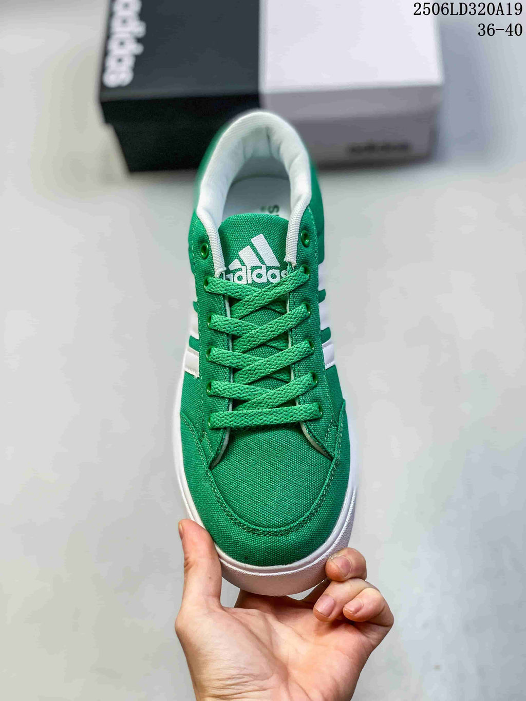 Top view of the green sneaker showing its laces, toe, and white lining