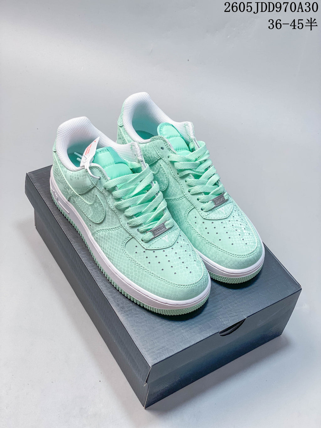 Pair of mint Nike Air Force 1 ’07 low-top sneakers with tonal laces