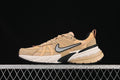 Side view of tan Nike V2K Run Runtekk sneakers with a silver Swoosh and sculpted sole