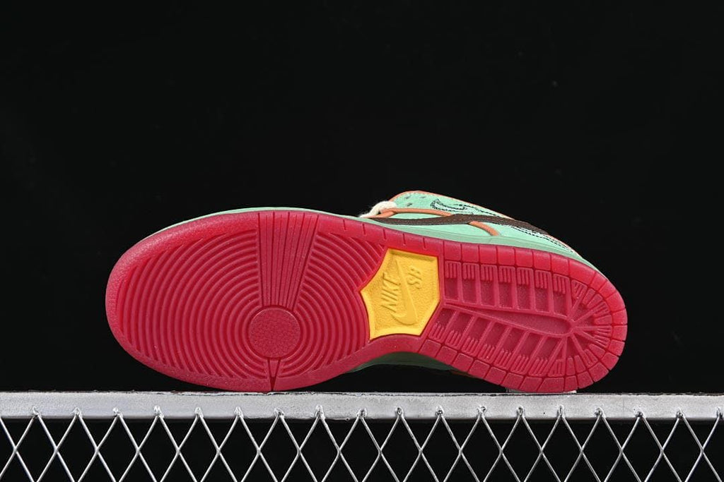 Underside view showing red rubber outsoles and yellow Nike SB inserts.