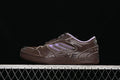Side view of dark brown Balenciaga Hamptons sneakers with lavender accents