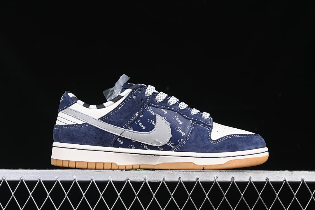 Side profile of the navy, grey, and white low-top sneaker