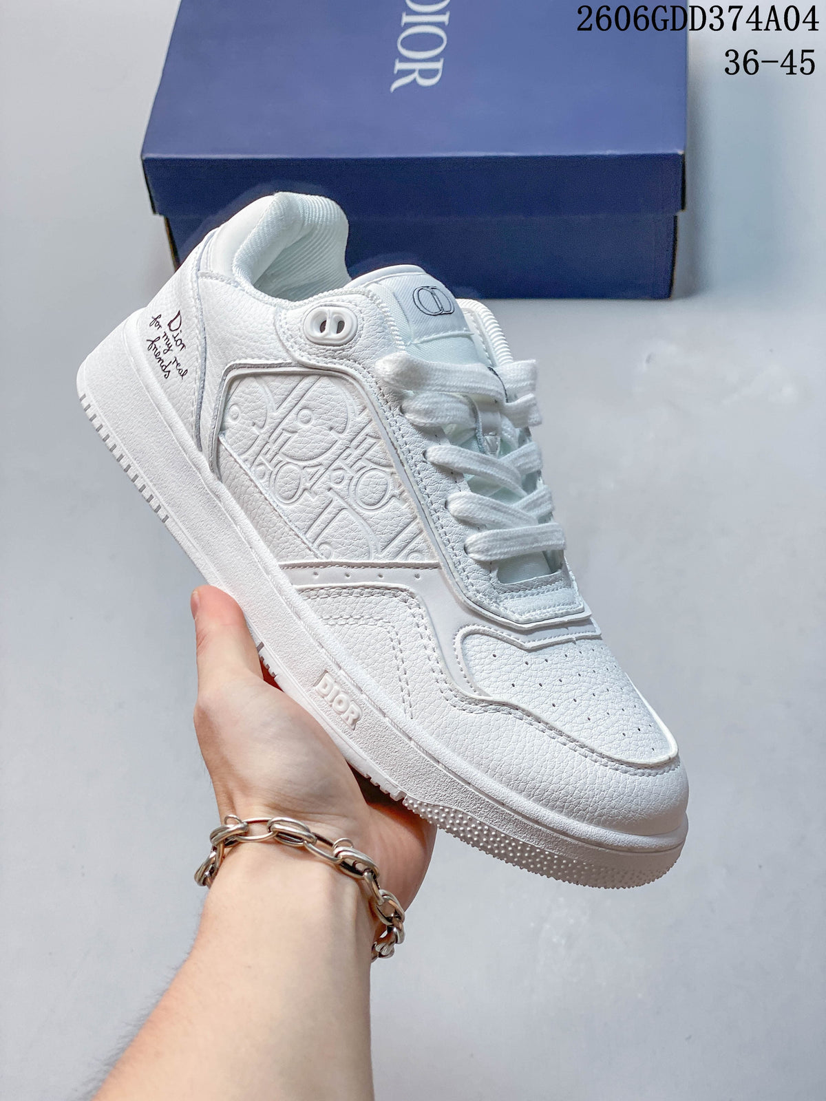 White low-top sneaker with an embossed patterned side panel.