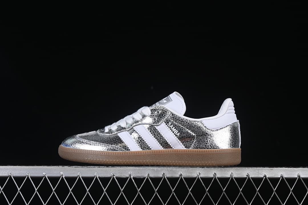 Side view of a silver-toned Samba OG sneaker with white stripes and gum-colored sole