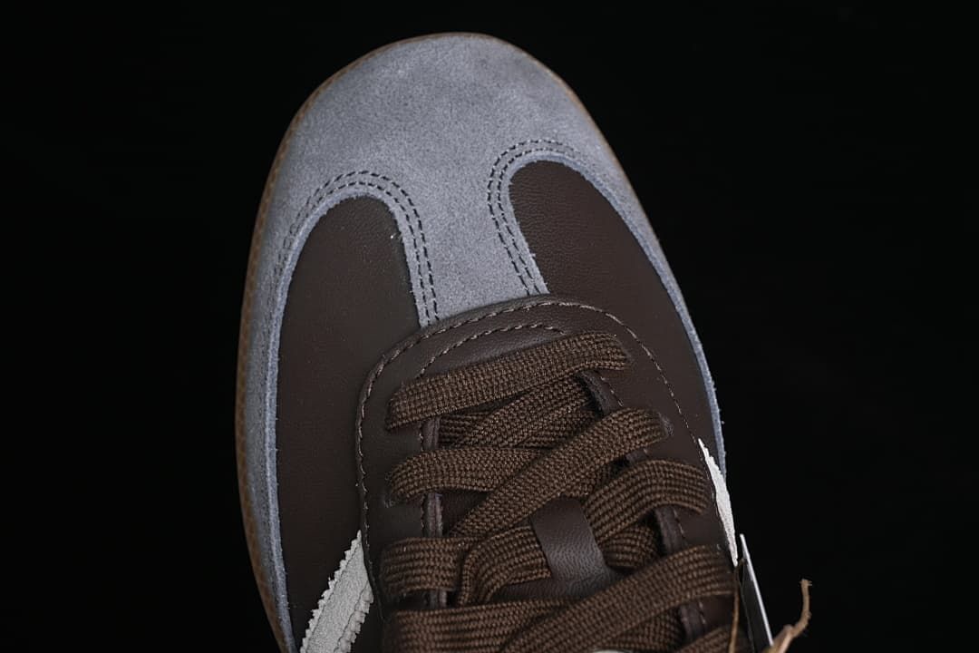 Top-down close-up of grey toe overlays and brown laces
