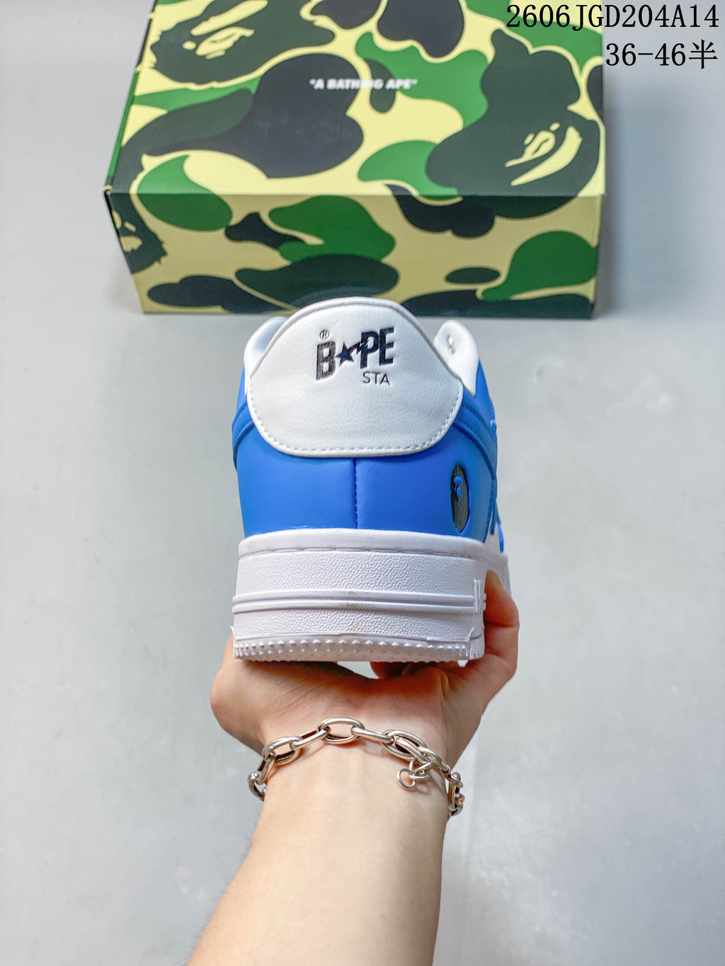 Rear view of the blue and white sneaker with BAPE STA tongue branding