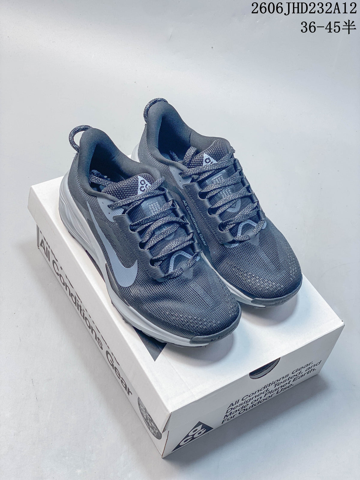 Pair of dark gray-blue Nike ACG Pegasus Trail shoes displayed on a box
