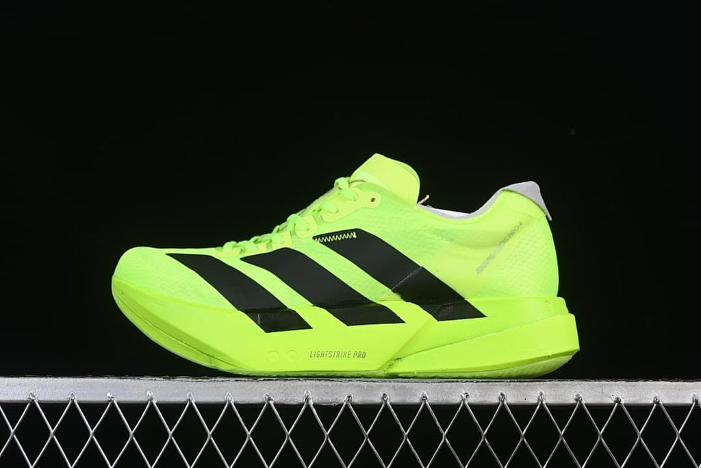 Lime green Adidas Adizero running shoe with black stripes, side view