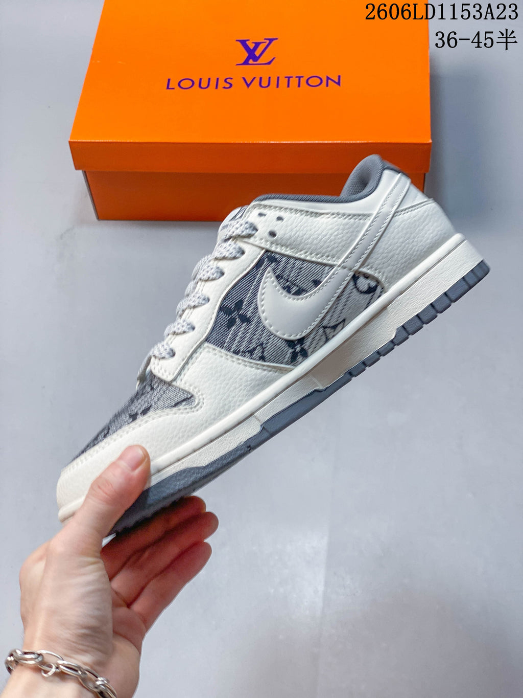 Side view of the off-white and gray low-top sneaker with patterned panels