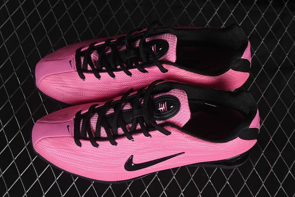 Pair of pink and black Nike Shox Z shoes viewed from above