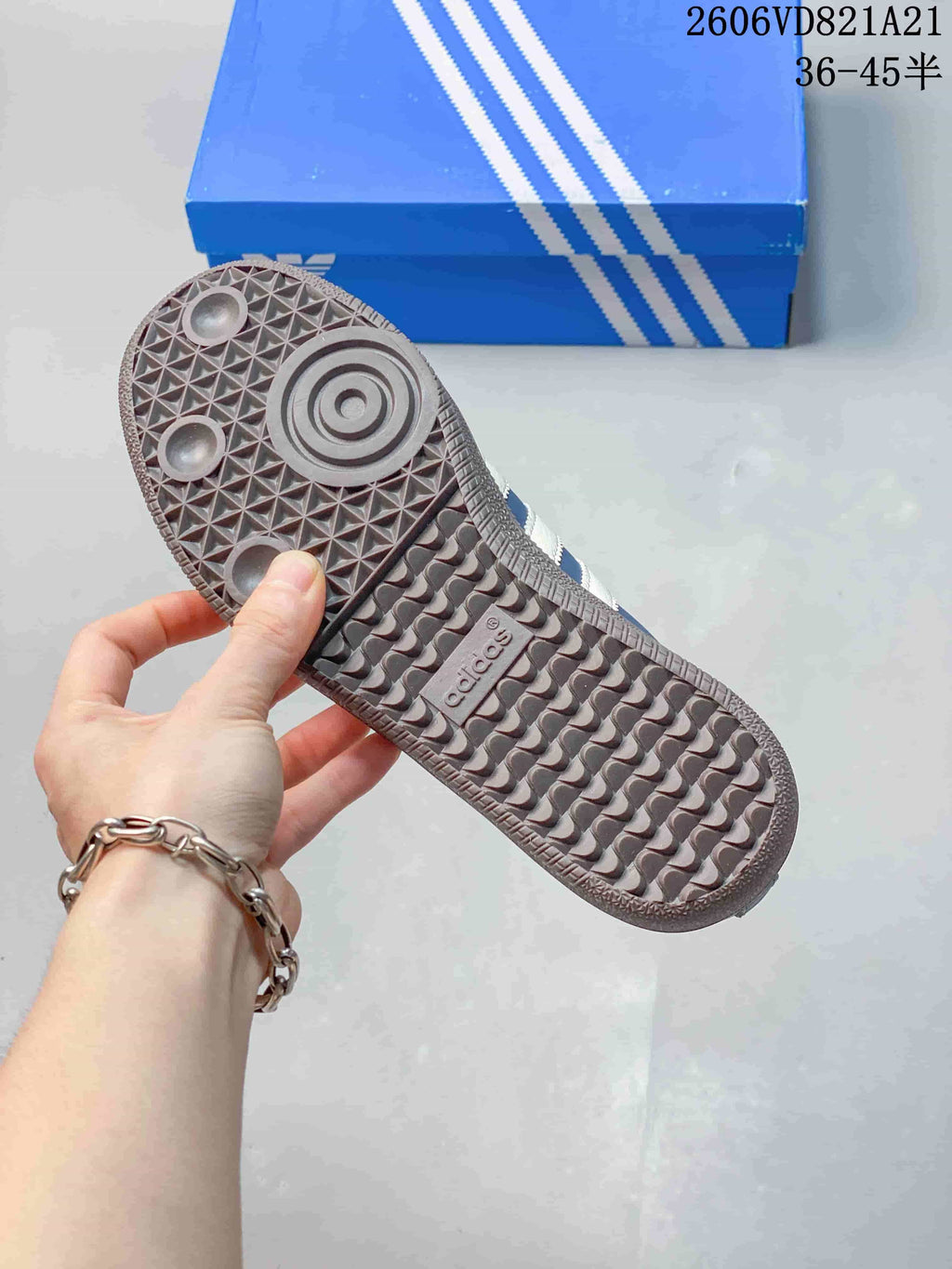 Close-up of the textured gum-tone outsole on the blue and white sneakers