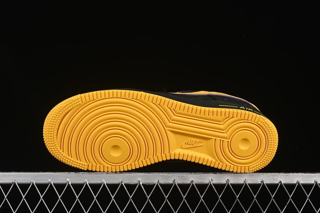 Underside view showing the yellow circular-pattern outsole.