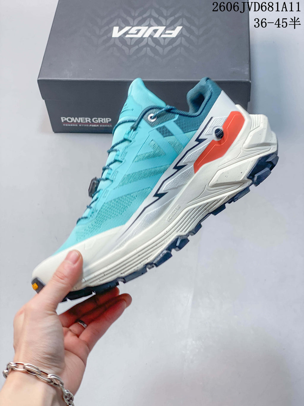 Side view of the turquoise low-cut trail shoe with white midsole and dial closure.