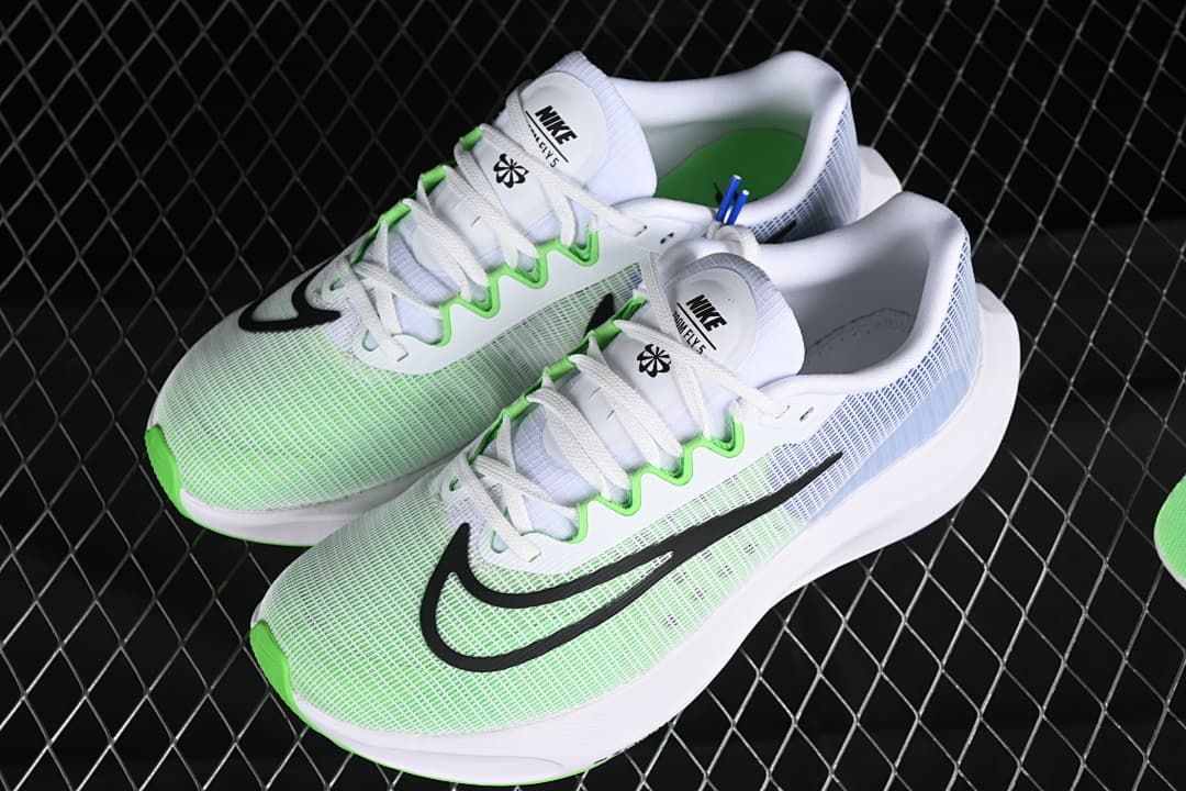 Pair of white Nike Zoom Fly 5 shoes with green and blue accents