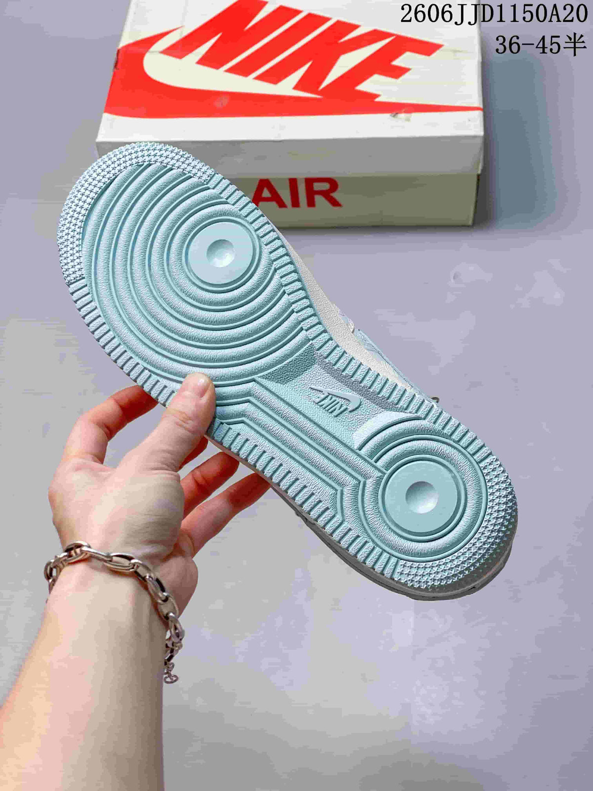 Close-up of the pale blue patterned outsole and circular tread details