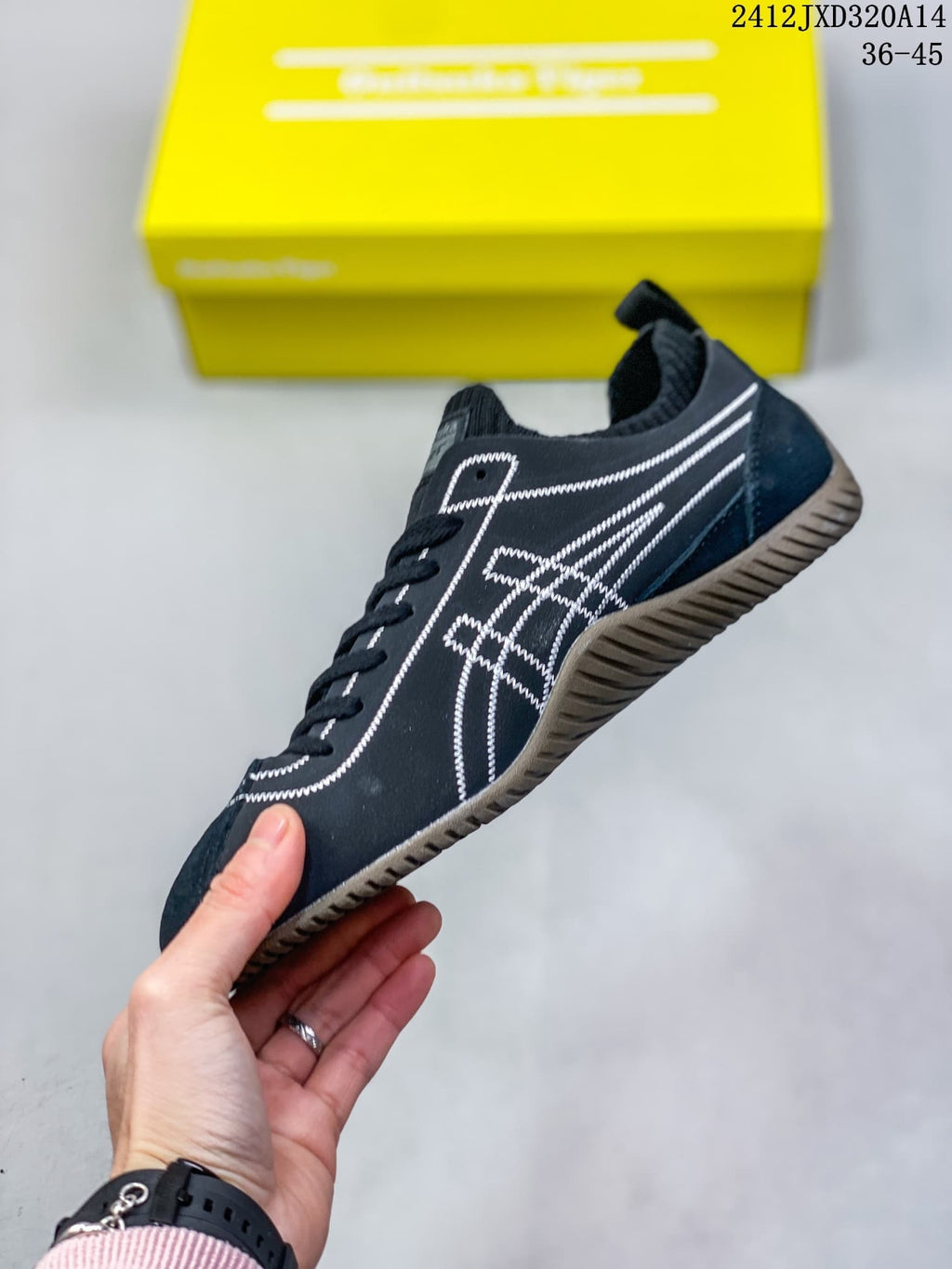 Side view of a navy SCLAW sneaker with white stitched details and a brown-toned outsole.