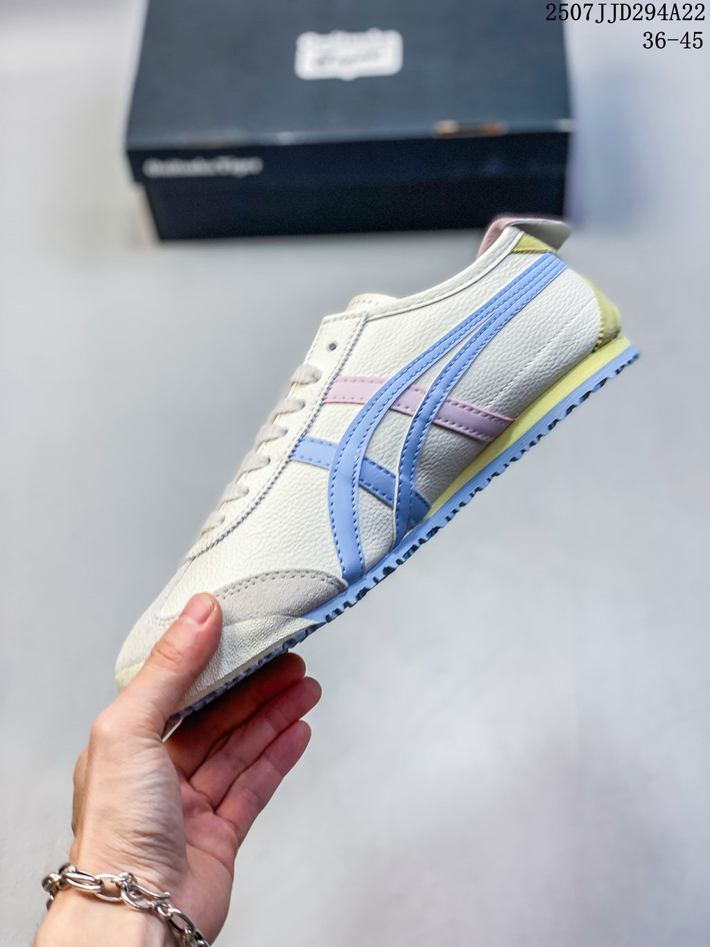 Side profile showing the cream upper, blue side stripes, pink accent and yellow heel detail.