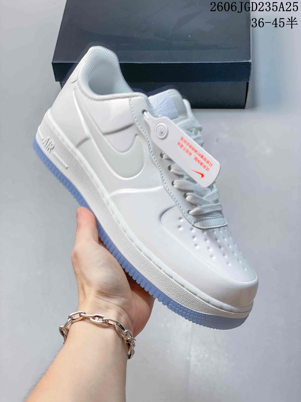 White low-top sneaker shown from the side with a pale blue outsole edge and Air-marked midsole