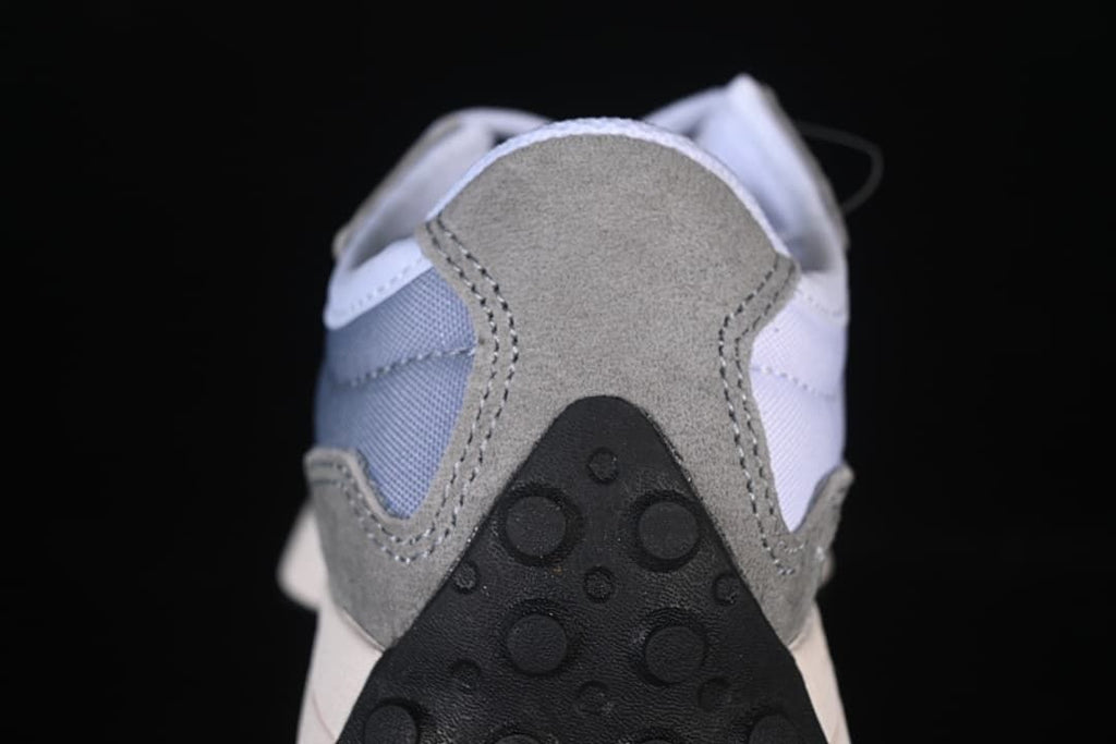 Close-up of the grey heel panel and black outsole detail.
