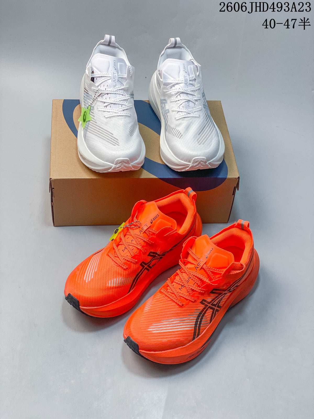 White and bright orange ASICS MAGIC SPEED FF TURBO running shoes shown together.