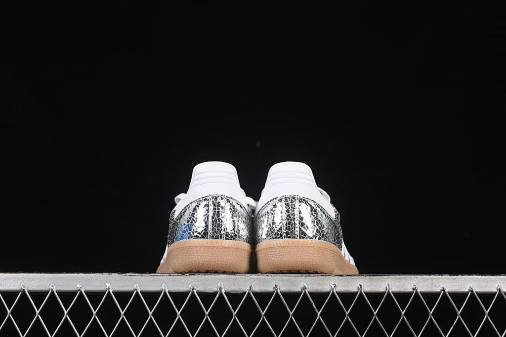 Rear view of both sneakers showing reflective heel panels and gum-colored soles